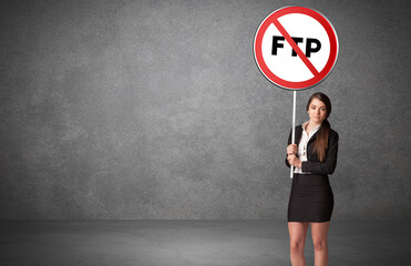 Young business person holdig traffic sign with FTP abbreviation, technology solution concept