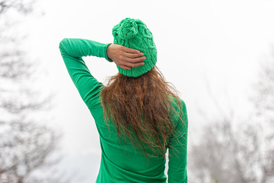 girl dressed in green with hat
