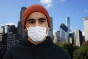 Man wearing hygienic mask to prevent infection, airborne respiratory illness such as flu, 2019-nCoV. Lonely young man wearing a mask for virus protection outside.