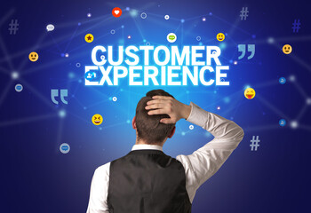 Rear view of a businessman with CUSTOMER EXPERIENCE inscription, social networking concept