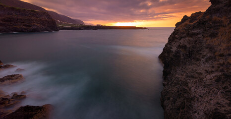 Coastal, sunset, long exposure landscape. Cliffs in San Marcos beach, Tenerife, Spain.