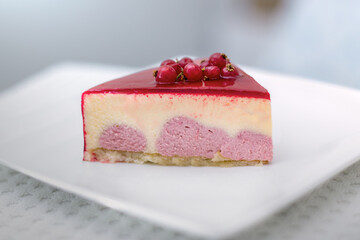 Piece of a red berries cake with red gelatine on top, close-up.