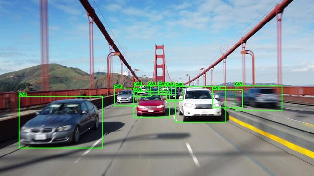 Artificial intelligence technology used in autonomous vehicle driving through Golden Gate Bridge in San Francisco. Computer vision object detection system creates boxes to recognize objects. Car POV.