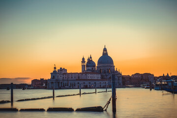 Obraz na płótnie Canvas Basilica of Santa Maria della Salute in Venice seen at sunset with no one in the Grand Canal due to covid-19