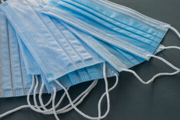 Medical masks on a gray background. There are many medical masks to protect against viral...