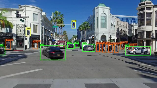 Autonomous car driving through Los Angeles. Computer vision with object detection system that creates boxes to recognize the different objects in the streets. Artificial intelligence technology.