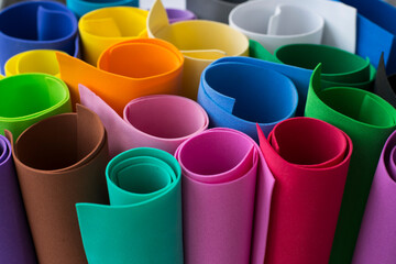 Foamiran sheets rolled into rolls. Material for creativity foam. Multicolored foam sheets rolled into rolls.