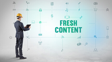 Engineer working on a new social media platform with FRESH CONTENT inscription concept