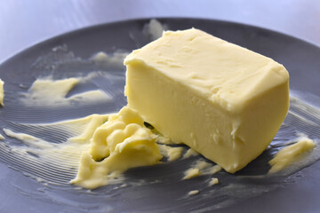 Butter on a black plate.  Copy space is on the left side. 
