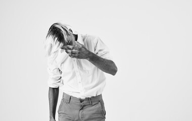 Handsome man in a shirt and trousers is gesturing with his hands the hairstyle model