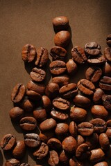 Coffee beans close up on a brown background. Coffee mood.