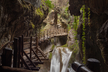 Obraz premium Stalactites and waterfalls in caves carved out of sandstone, Caglieron caves, Veneto, Italy