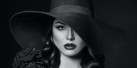 Portrait of a beautiful woman with red lips in a hat, toned in color of the year 2020, classic blue.