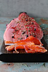 Gravlax, scandinavian beet cured spiced salmon on the board, top view, salted red fish