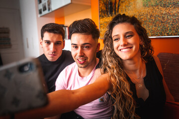 Obraz premium Three guys taking a selfie at the sofa