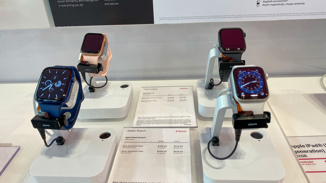  Four Apple Watches Series 6 with various colored watch faces and bands.