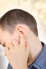 little boy holds on to the ear, part of the face close-up, medical concept, hearing control, middle ear inflammation, otitis media