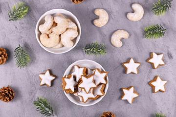 White bowls with traditional German and Austrian Christmas cookies, one filled with cinnamon star...