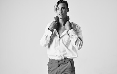 Fototapeta na wymiar beautiful gentleman in a shirt on a light background gray photograph model