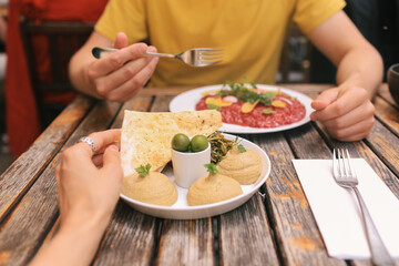 Couple Eating Lunch with Hummus and Risotto