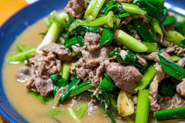 A delicious Chinese dish, fried lamb with celery and garlic sprouts