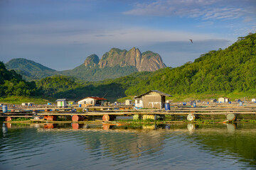 Morning view of the lakes with mountain reflection on background. Floating house on the lakes. Beautiful view in the countryside. 