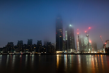 Blue photo dawn photo of london skyline in fog over St Georges Wharf at Vauxhall.