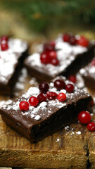 Christmas chocolate cakes with cranberries and powdered sugar. Good New Year spirit.