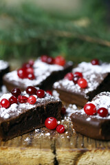 Christmas chocolate cakes with cranberries and powdered sugar. Good New Year spirit.