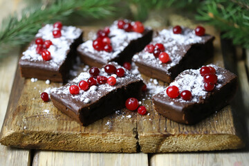 Christmas chocolate cakes with cranberries and powdered sugar. Good New Year spirit.
