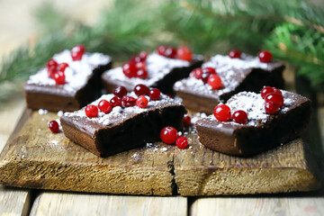 Christmas chocolate cakes with cranberries and powdered sugar. Good New Year spirit.