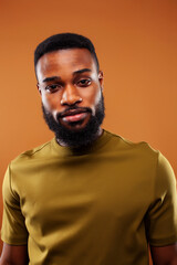 young pretty african american man posing cheerful on brown background, lifestyle people concept