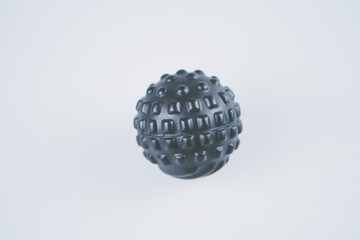 Black massage ball isolated on white background 