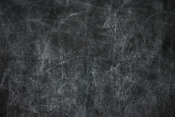 back to school: black chalkboard with blurry traces of white chalk and crayons, minor scratches