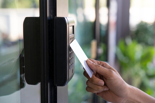 young woman using RFID tag key, fingerprint and access control  to open the door in a office building
