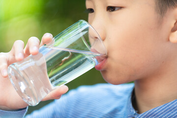 Young Asian boy drink water