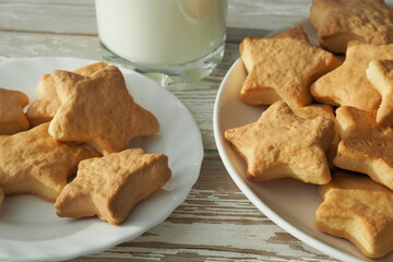 Homemade cookies and a glass of milk on a rustic table