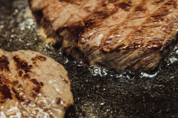 Beef steaks Sizzling in a pan of boiling oil.