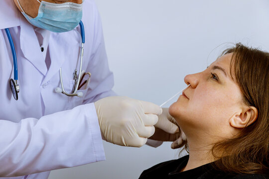 Doctor worker taking a swab a coronavirus COVID-19 test for in female plr test