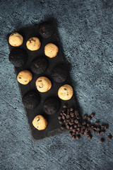 Mini chocolate chip cookies served on an elegant black plate - gourmet snacks - fine pastries