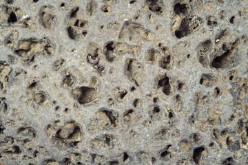  Rough weathered  stone surface with erosion and holes, close up