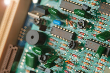 A green electronic circuit board background, close up