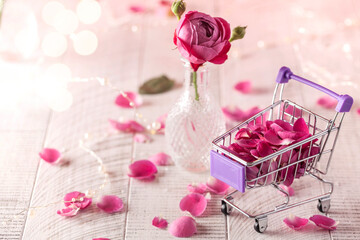 Rose petals on a wooden background. Valentine's day card, March 8. Copy space.