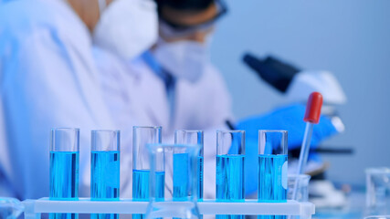 Group of Asian scientists doing some research in the laboratory.