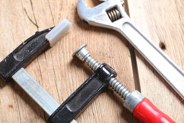 carpenter's tools lie on a wooden table clamp plane