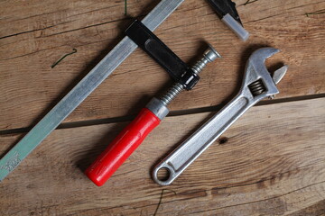 carpenter's tools lie on a wooden table clamp plane