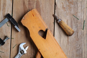 carpenter's tools lie on a wooden table clamp plane