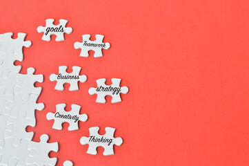 Top view of jigsaw puzzle piece with text motivation, covering text success and different words.