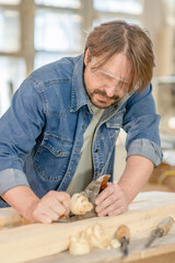 Carpenter planed wood in a workshop