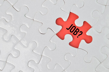 Fototapeta premium Top view of jigsaw puzzle with word JOB?. Business concept. 